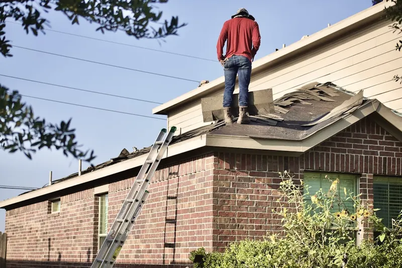 Professional roofer working on a residential roof in Howell Estates